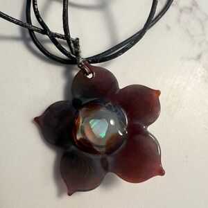 Blown glass flower pendant with suspended o pal & leather necklace cord.